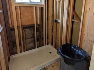 A photo of a bathroom shower in the middle of a rebuild.