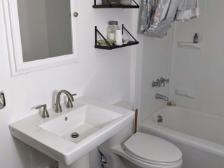 A photo of a well-lit bathroom.