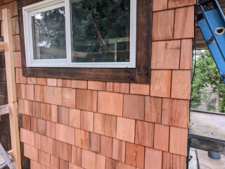 A close-up view of some newly-installed cedar shake siding.