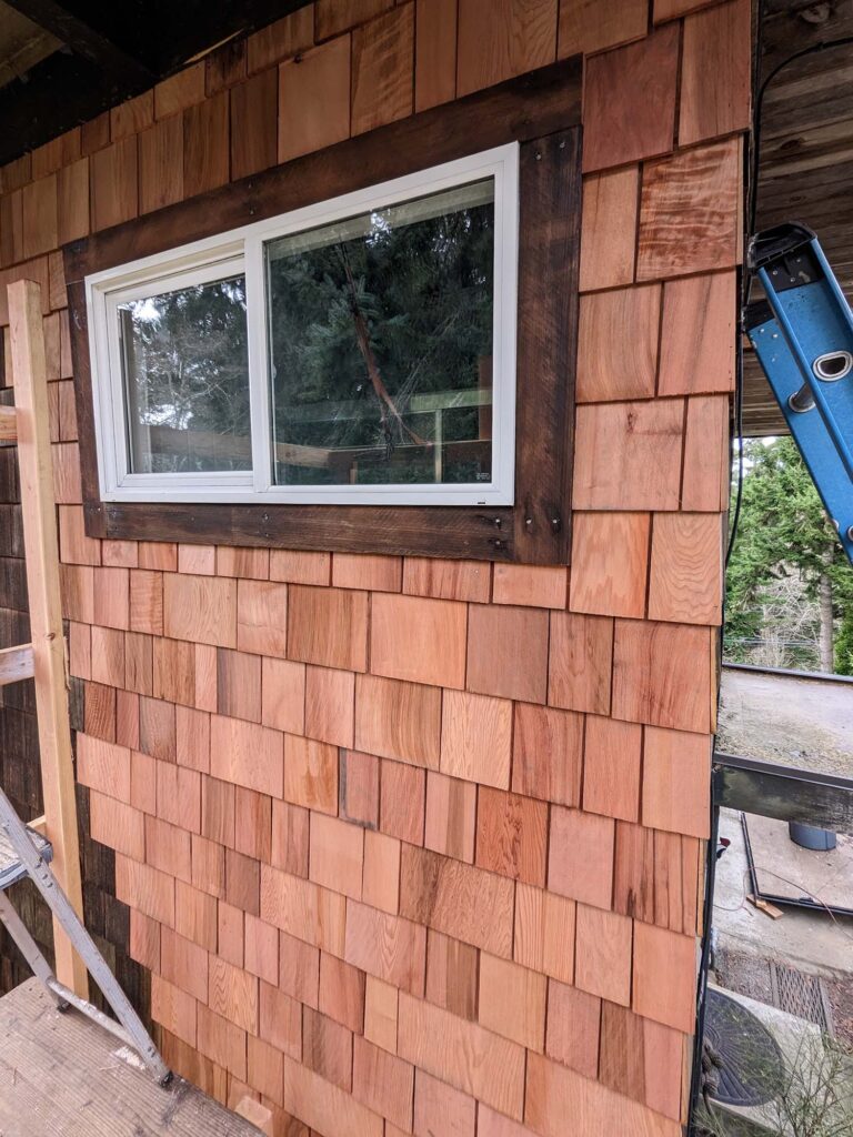 A close-up view of some newly-installed cedar shake siding.